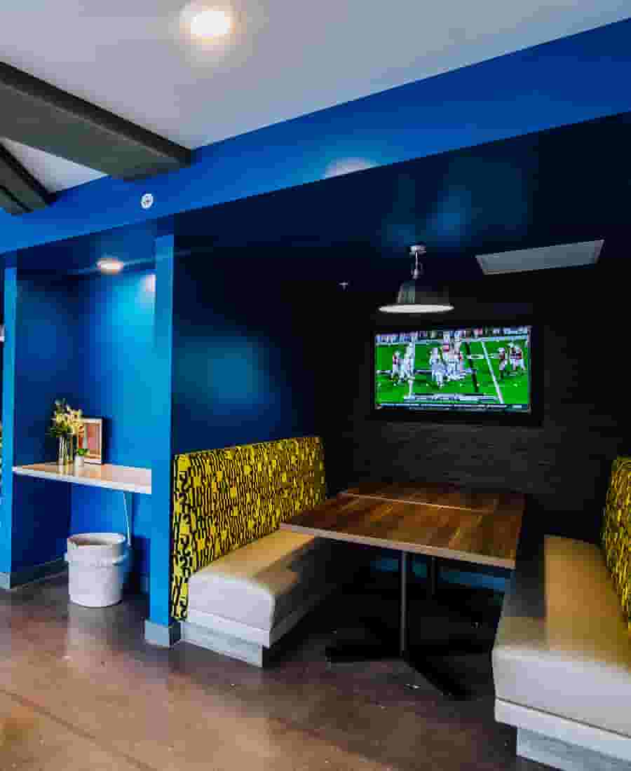 Private booth in the Club Lounge with mounted TV