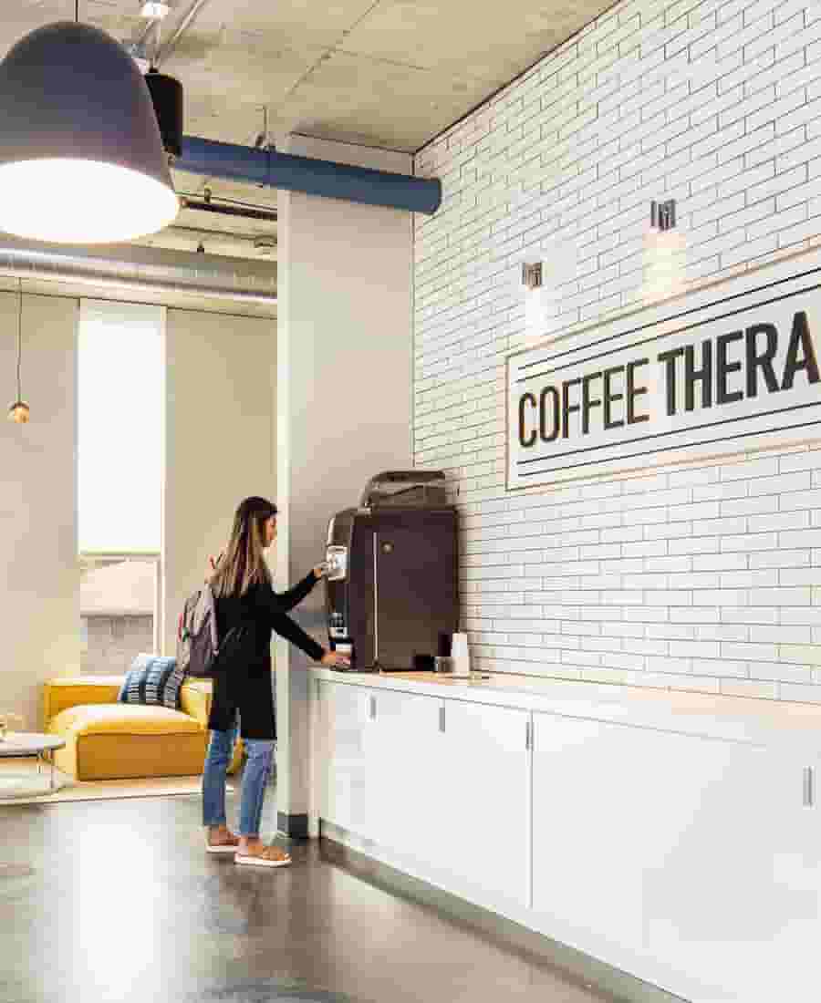 Coffee bar with automatic latte machine and white subway tile