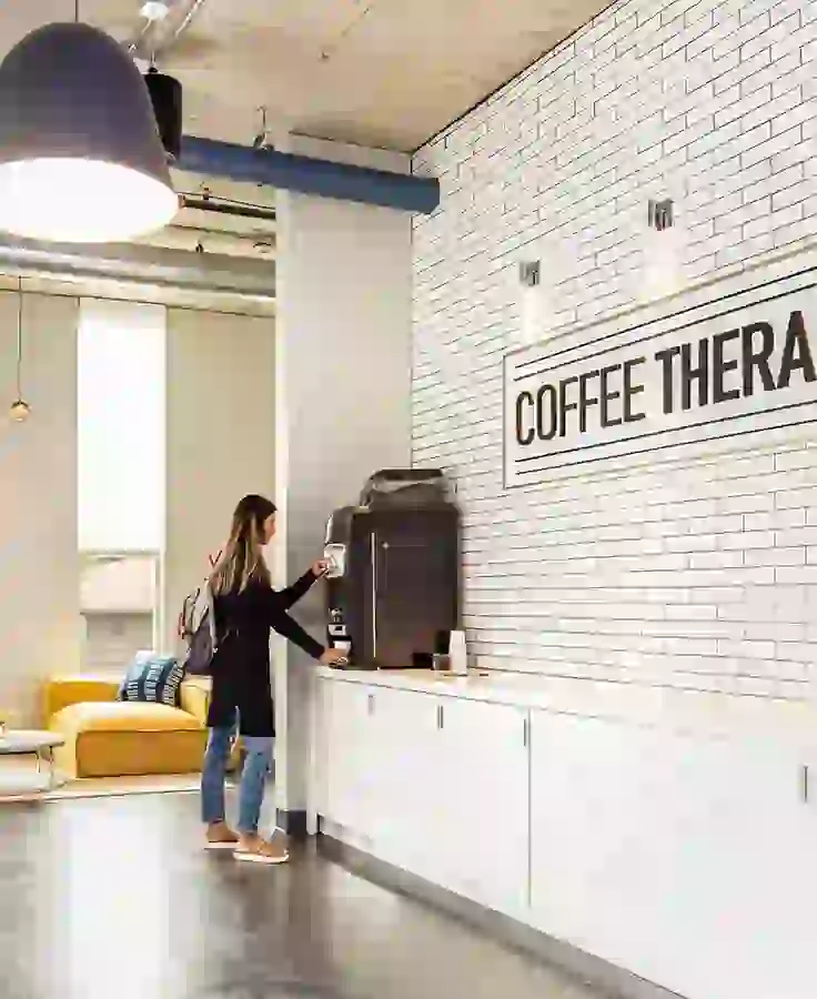 Coffee bar with automatic latte machine and white subway tile