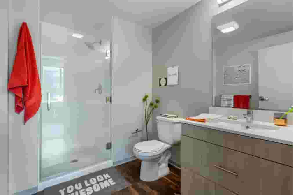 Student bathroom with glass shower doors